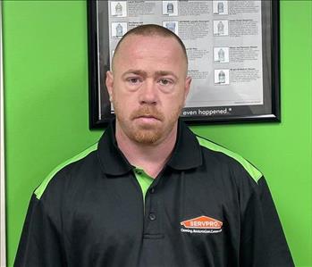 Employee in front of SERVPRO signage