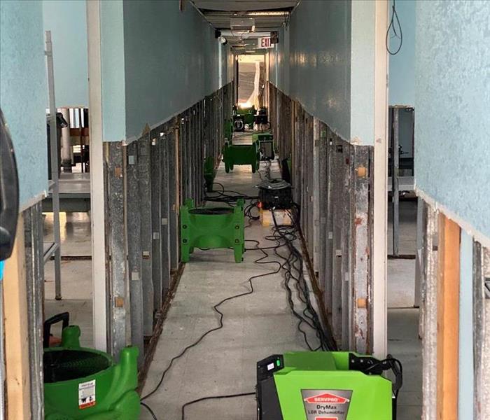 Water damaged hallway with drying equipment set in Goulding, Florida