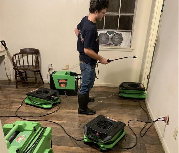 SERVPRO crew and drying equipment in use during a water damage restoration job