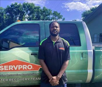SERVPRO employee standing in front of service truck.