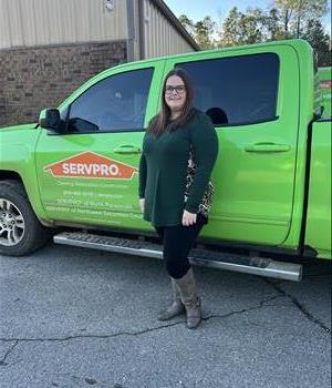 Picture of Kara Dixon on a green background wearing a SERVPRO logoed shirt