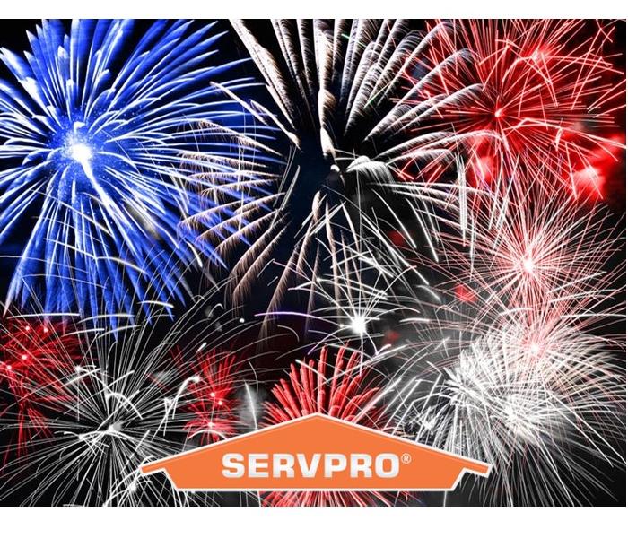 Fireworks on a night sky with SERVPRO logo in front