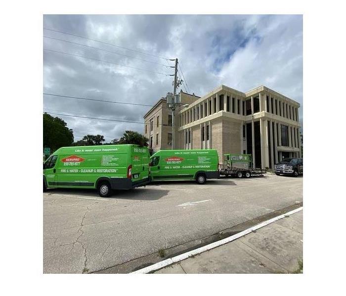 SERVPRO vehicles in front of a commercial building