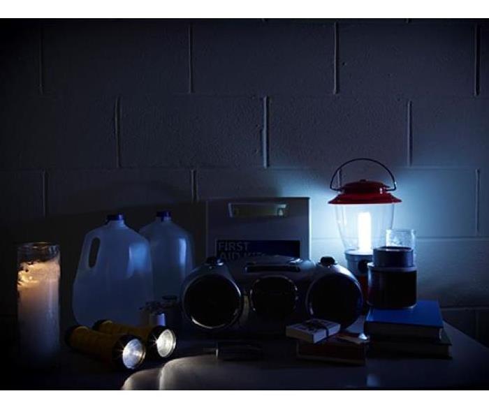 Lantern lighting a dark room with storm supplies